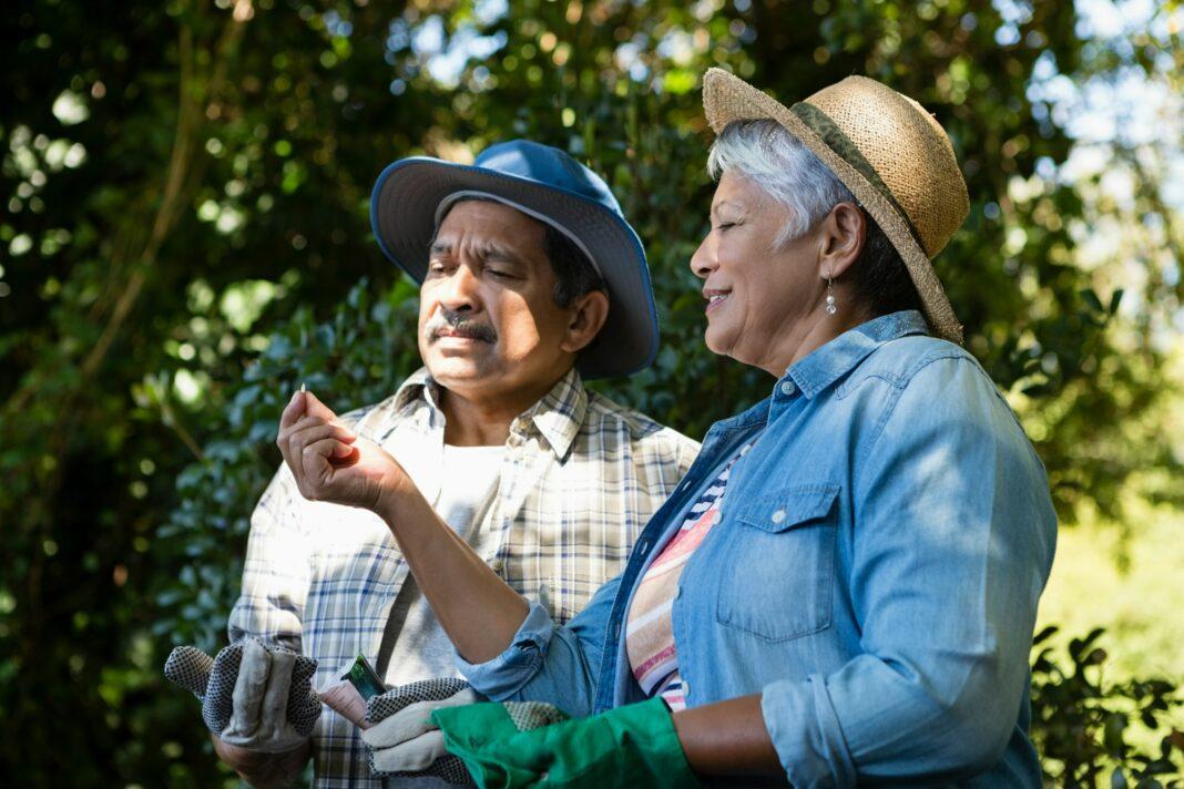 Couple interacting with each other while gardening in the garden