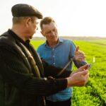 Farmers with tablet in the field. Smart farm. Agriculture, gardening or ecology concept.
